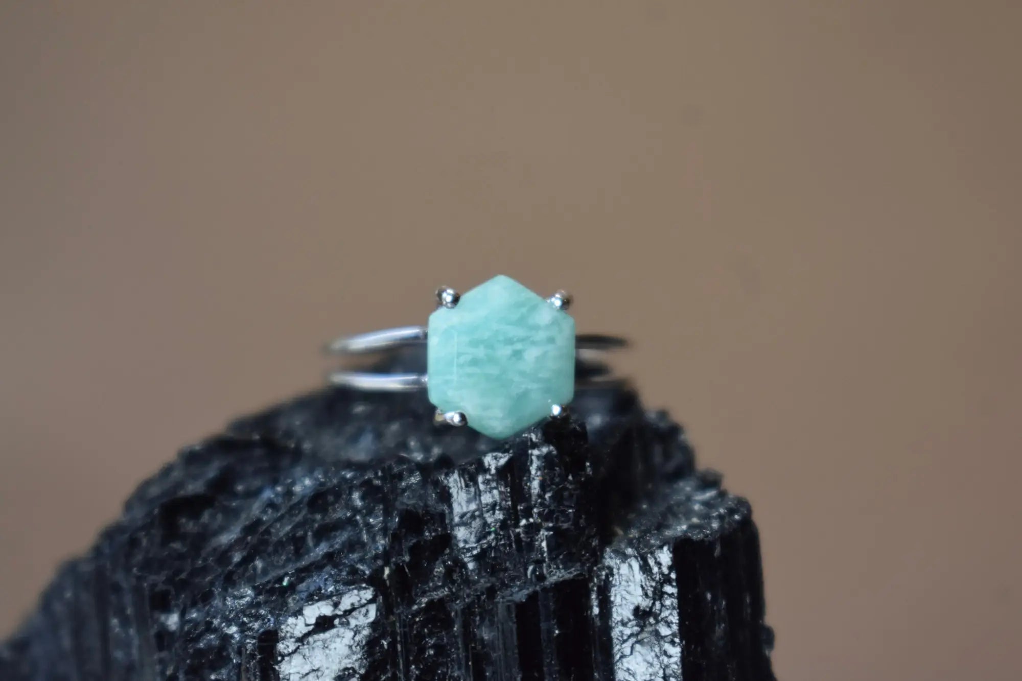 Turquoise stone ring with silver band symbolizes emotional strength alongside Amazonite earrings.