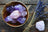 Bowl of raw Amethyst and Rose Quartz with dried lavender for jewelry saving lives.