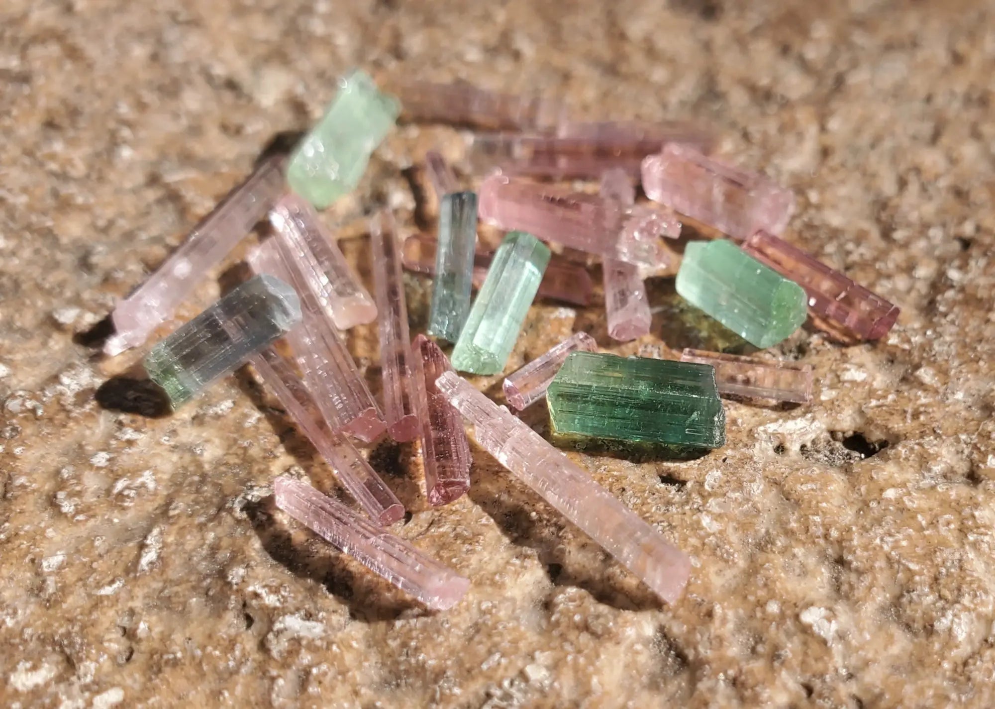 Pink and green tourmaline crystals showcasing the beauty of October birthstone.