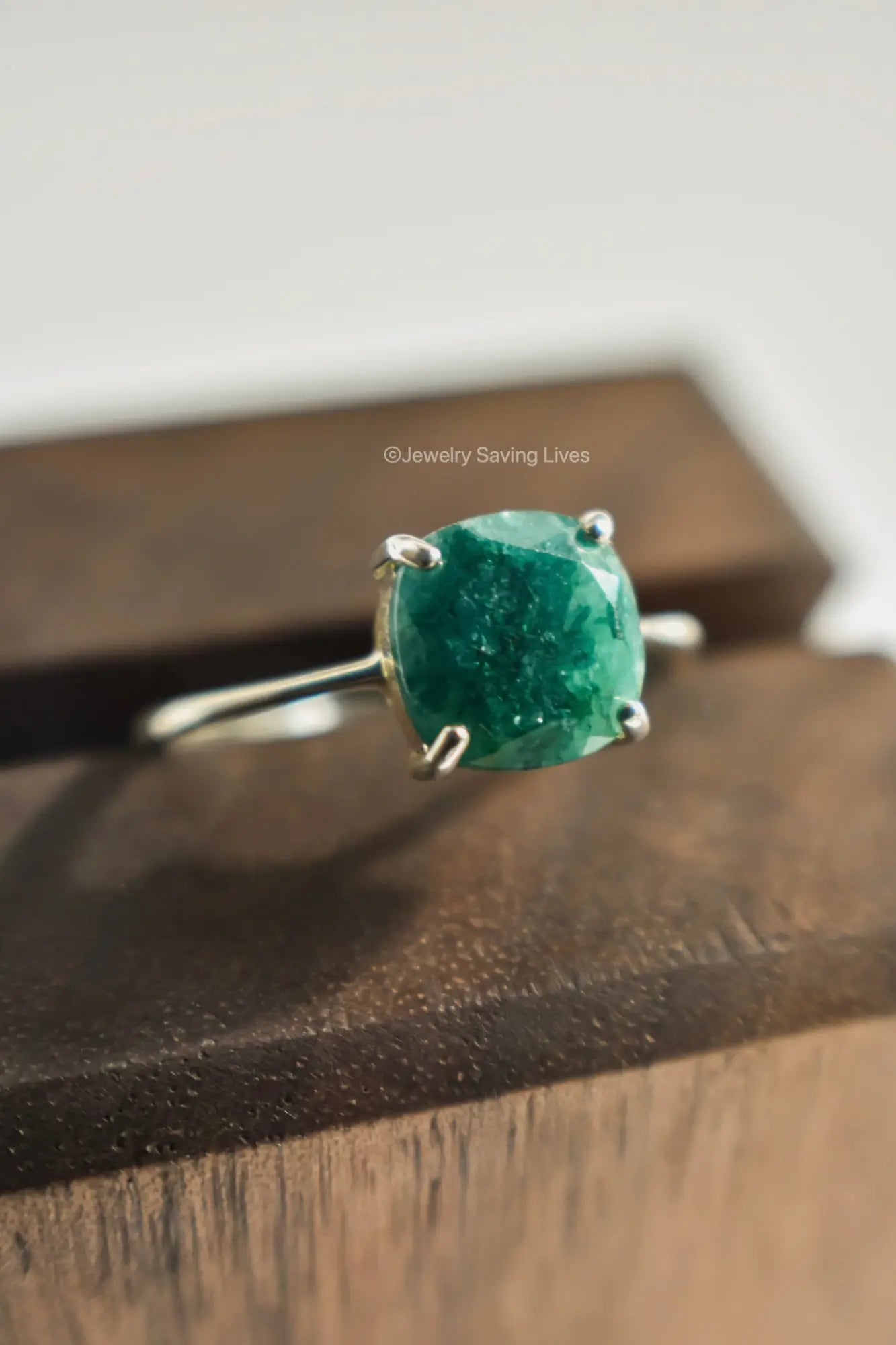 Sterling silver ring with cushion-cut natural emerald, ideal for engagement rings.