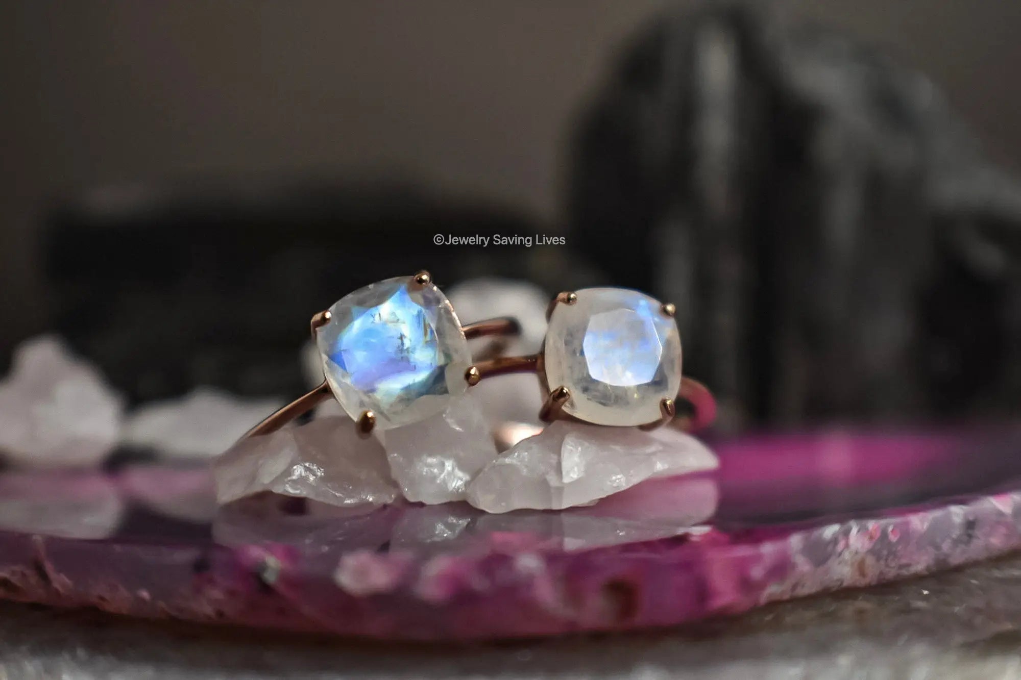 Ring featuring two cushion-cut moonstone gems in gold setting, June birthstone beauty.