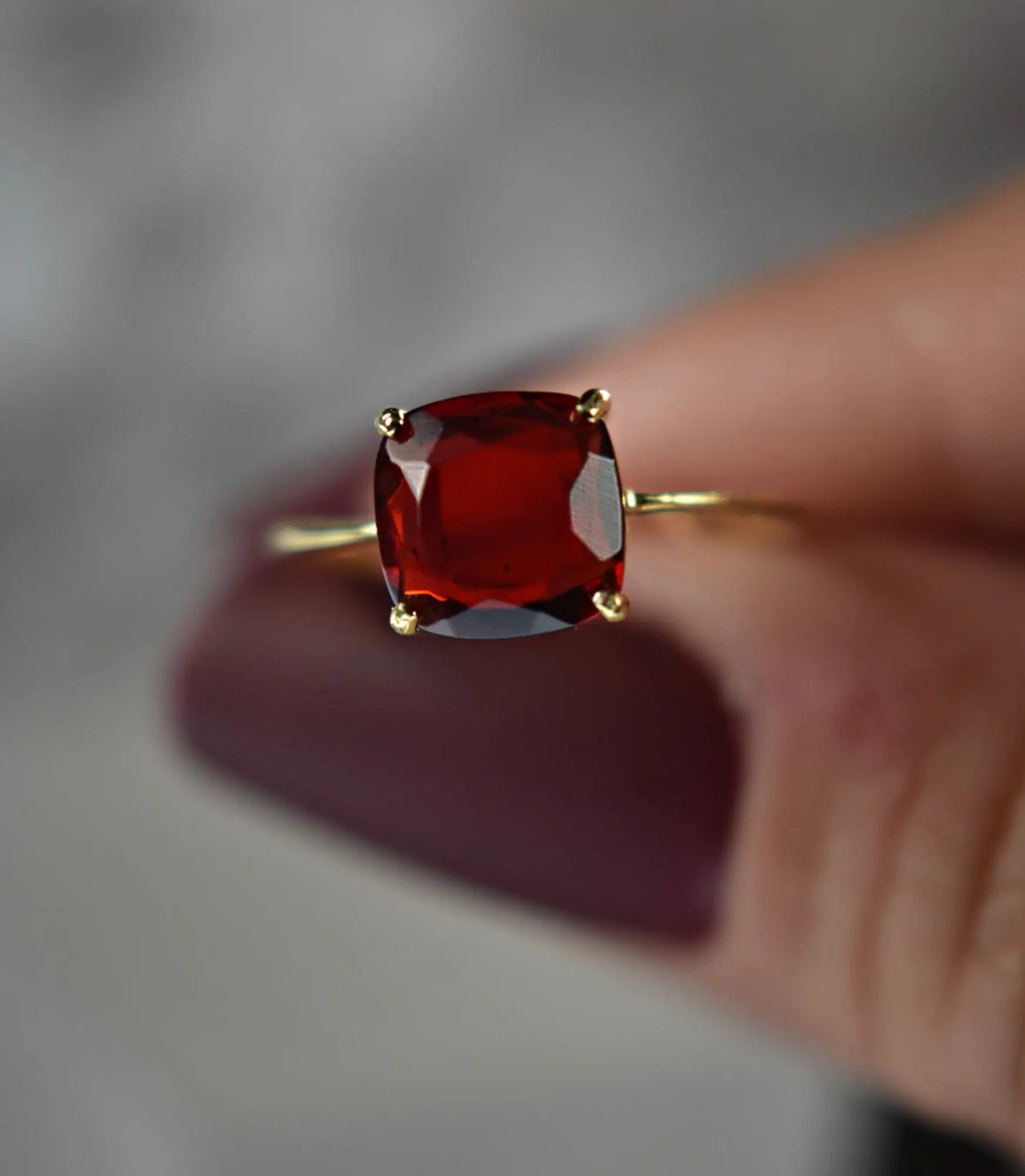 Square-cut red Garnet ring in gold prongs from the January birthstone collection.