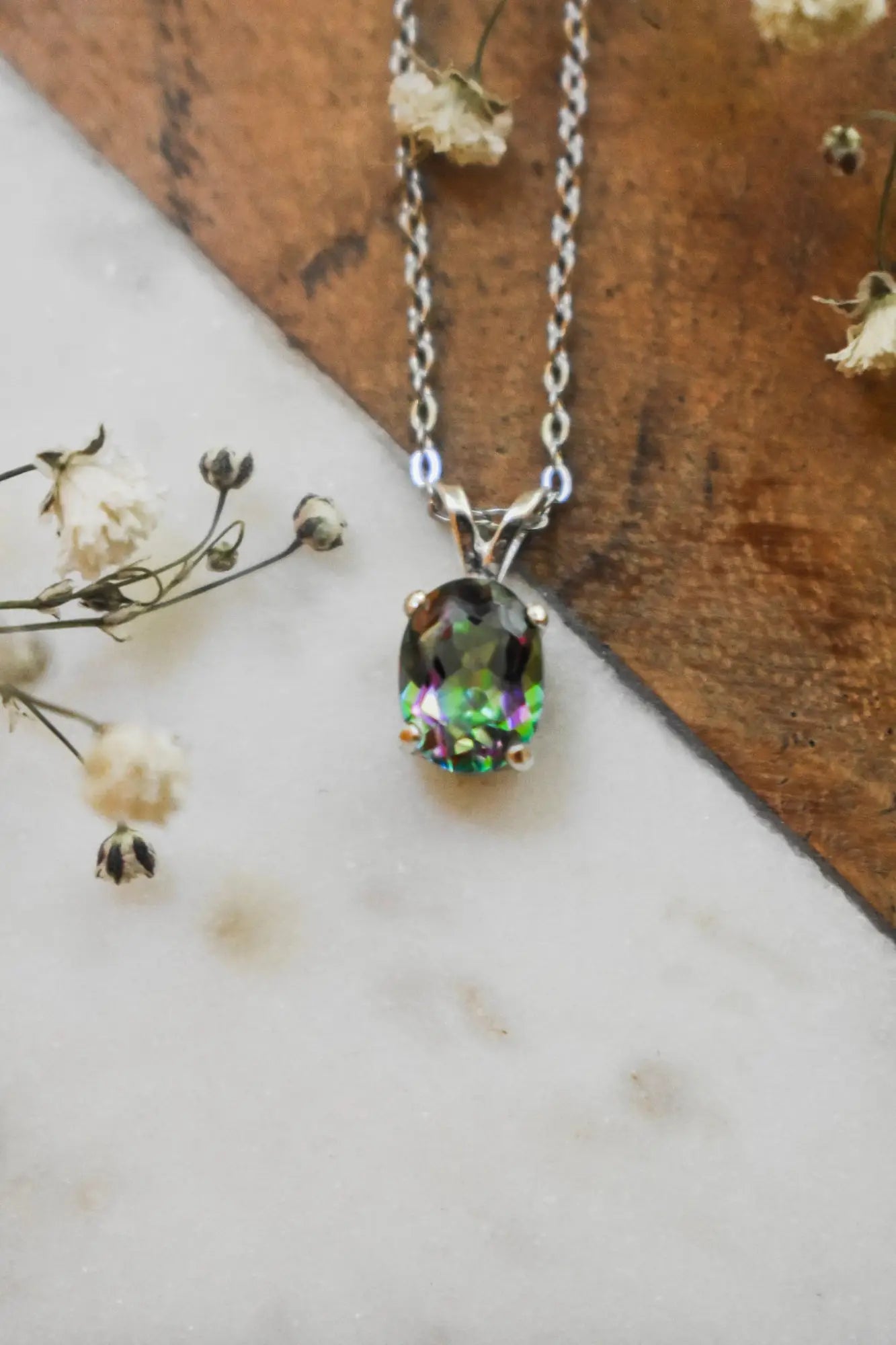 Silver necklace featuring an oval Mystic Topaz pendant, June birthstone color changing beauty.