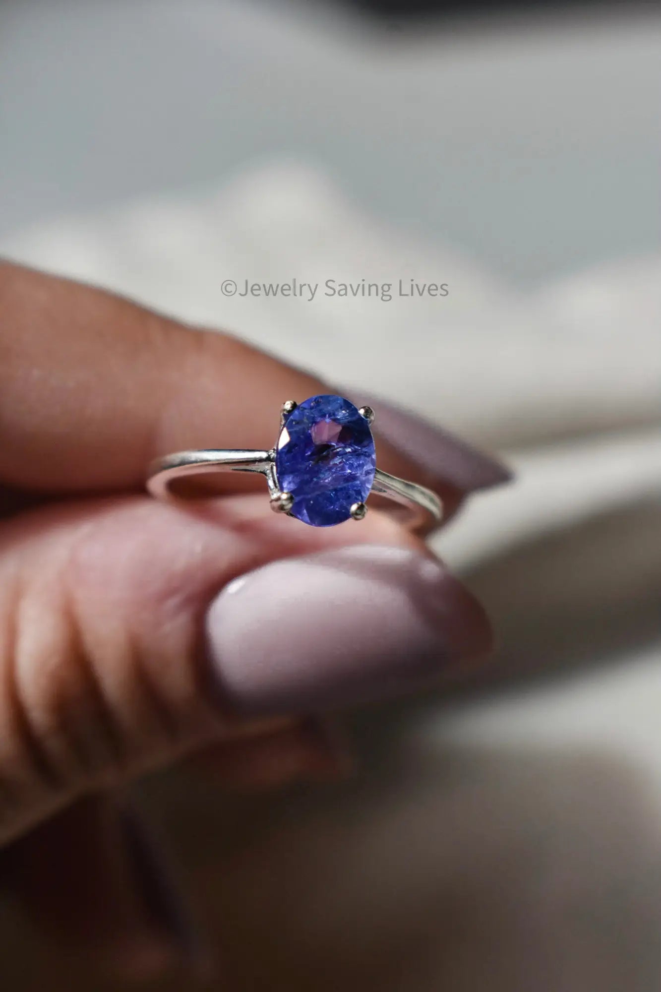 Silver ring with oval natural Tanzanite gemstone from December birthstone collection.