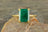 Emerald-cut green gemstone in a gold ring, a stunning natural emerald engagement ring.