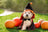 White fluffy dog in witch costume surrounded by pumpkins at Halloween Giveaway Winners event.
