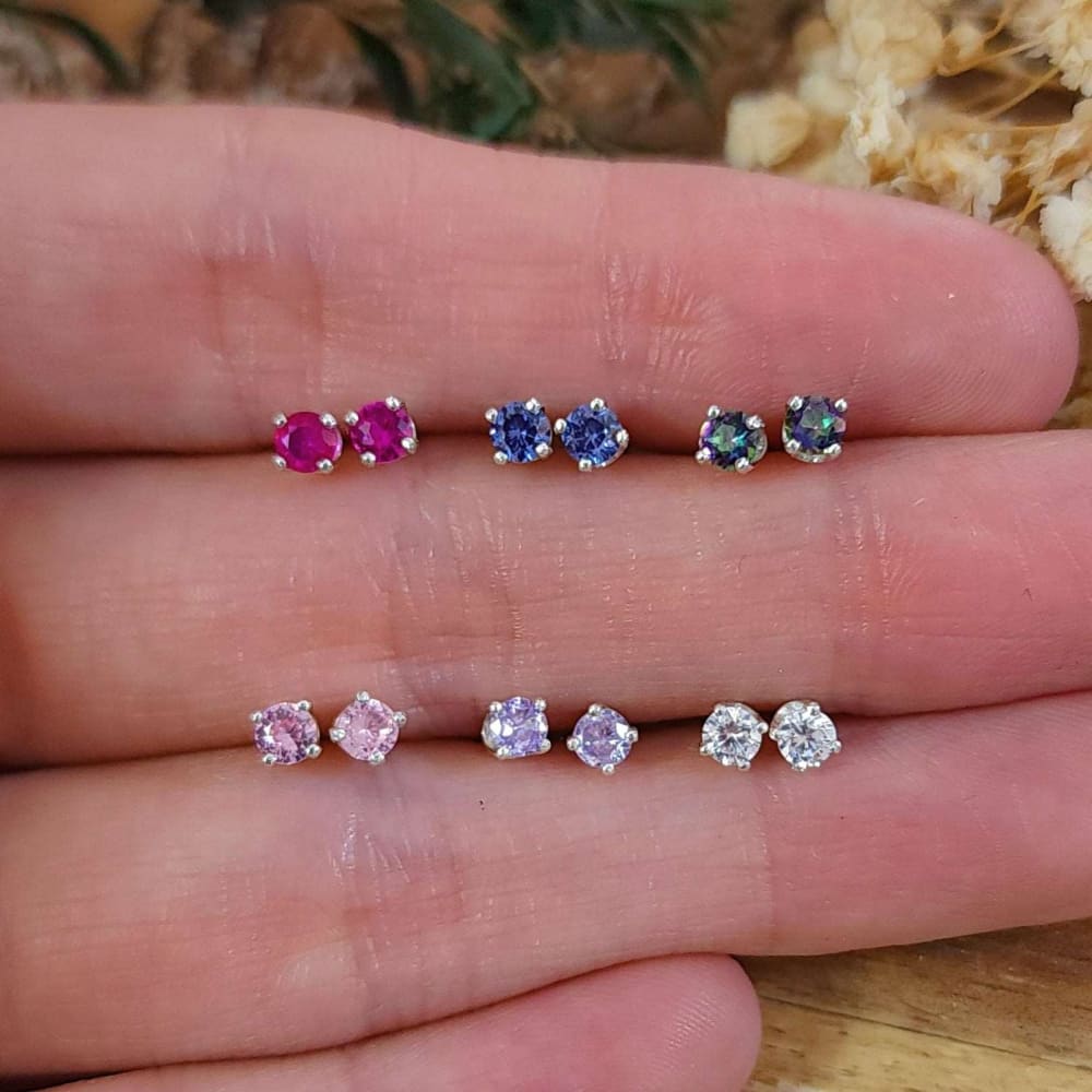 Six pairs of colorful 3mm stud earrings in rows, showcasing stylish gemstone designs