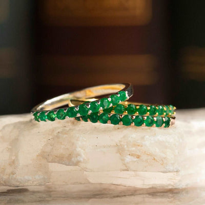 Elegant Gold Rings with Emerald Green Gemstones in an Emerald Half Eternity Band