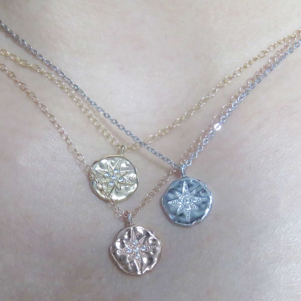 Three delicate snowflake medallion necklaces on silver chains, perfect celestial coin necklace