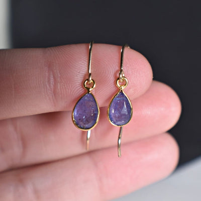 Purple natural teardrop tanzanite earrings with gold wire hooks, ethically sourced design