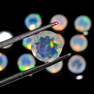 Opal gemstone held by tweezers displaying vibrant rainbow-colored fire and iridescence.