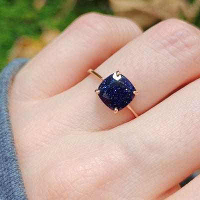 Gold ring showcasing a cushion-cut blue sandstone gemstone in The Asher design