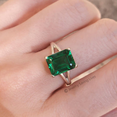 Emerald-cut green gemstone in The Audrina Emerald Ring with silver band